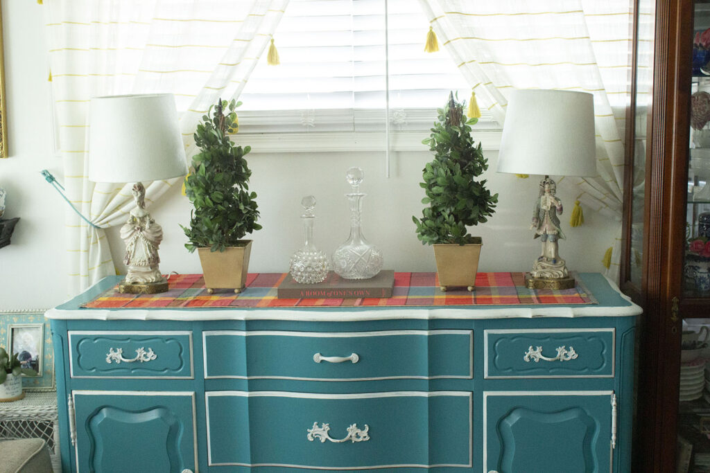 Turquoise blue buffet table with topiaries and French figurine lamps