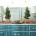 Turquoise blue buffet table styled with French figuring lamps and topiaries