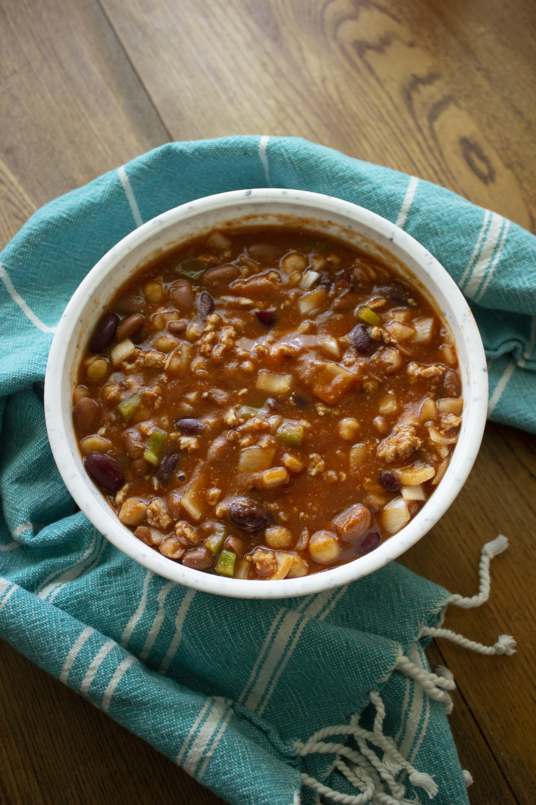 Bowl of chili with blue towel