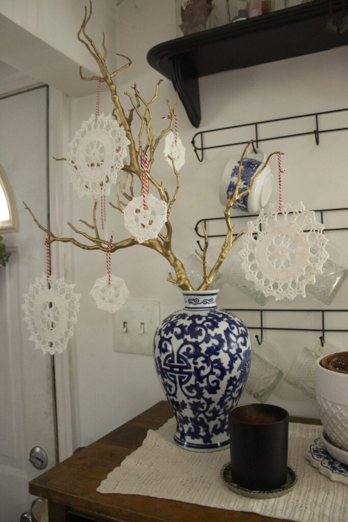 golden branch with doily ornament