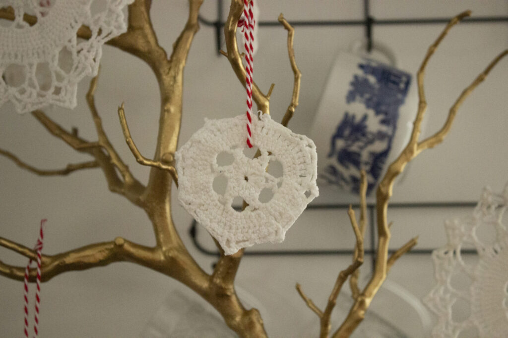 golden branch with doily ornament