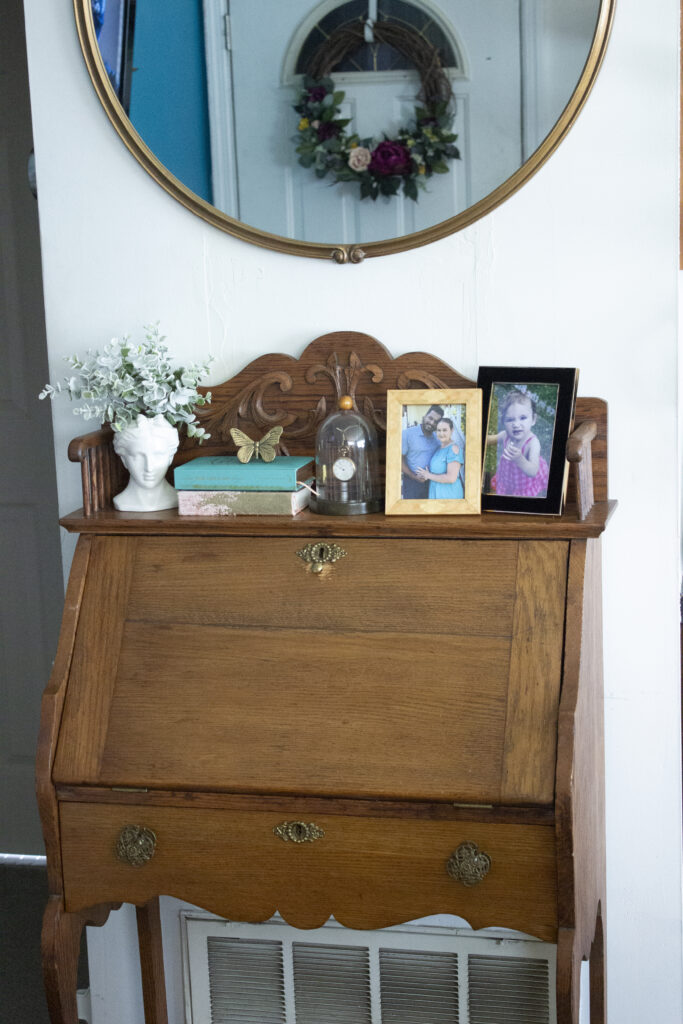 A vintage secretary desk styled in maximalist fashion