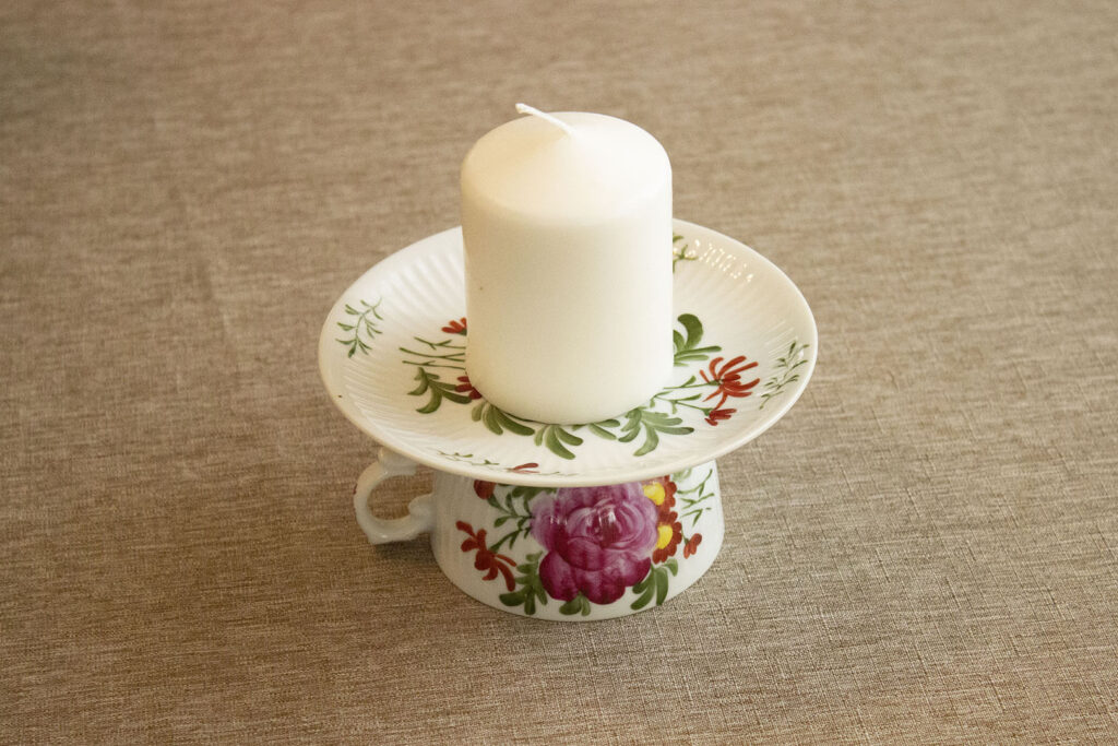 what to do with old china: teacup with saucer used to hold a candle