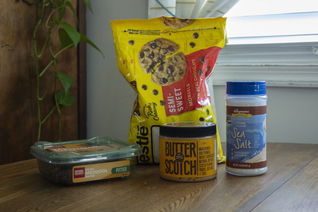 Dates, Butterscotch peanut butter, sea salt, and chocolate chips on table