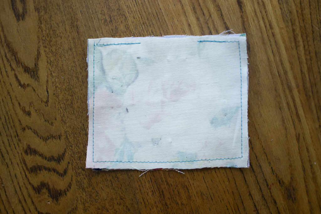 Square fabric with stitching around the edges