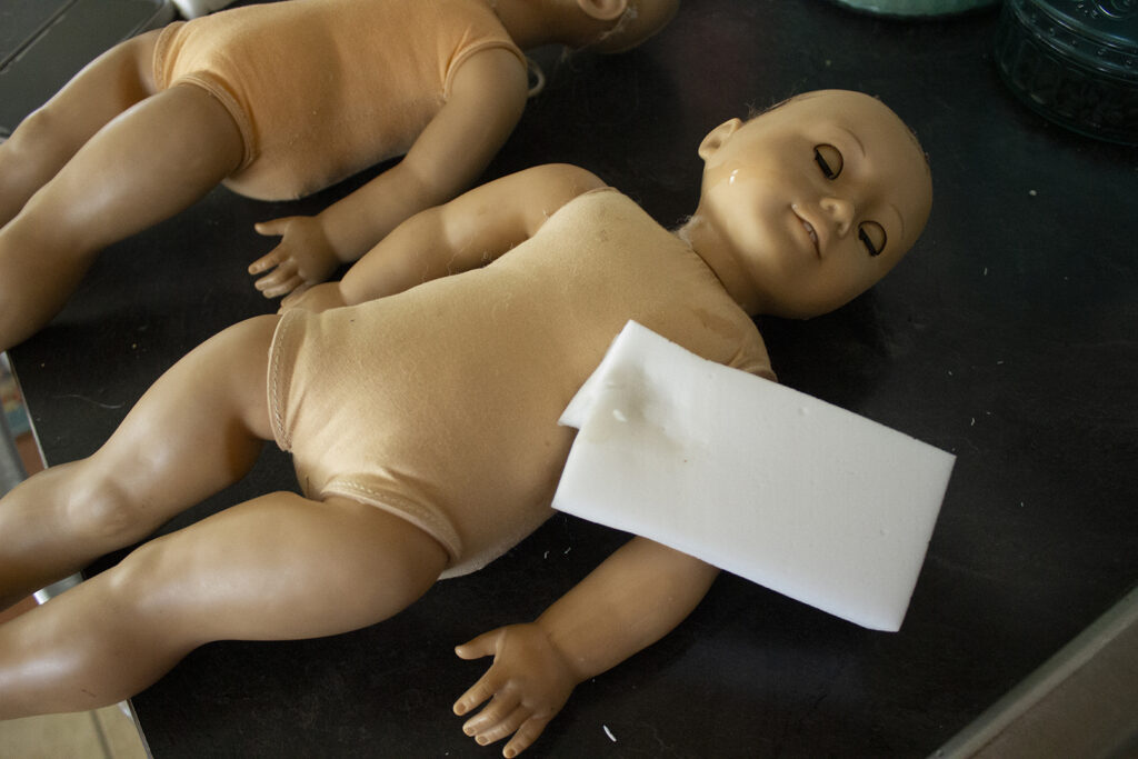 Cleaning an American Girl doll with a Magic Eraser