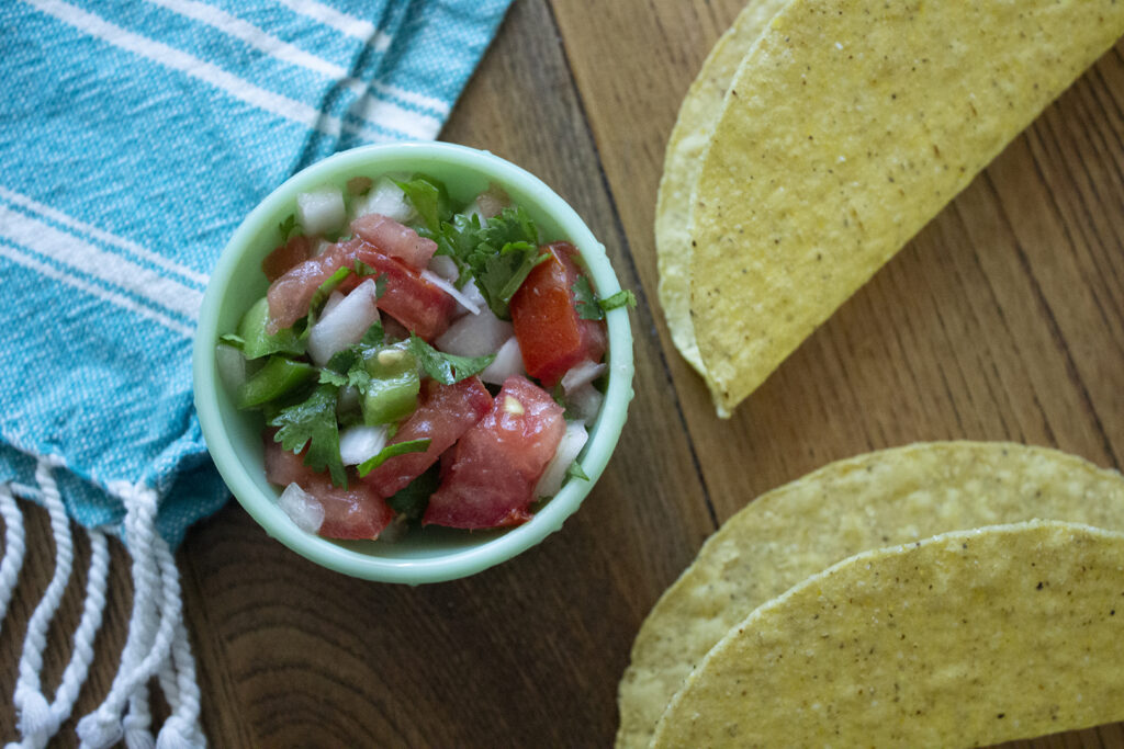 Homemade Pico de Gallo with two crispy taco shells