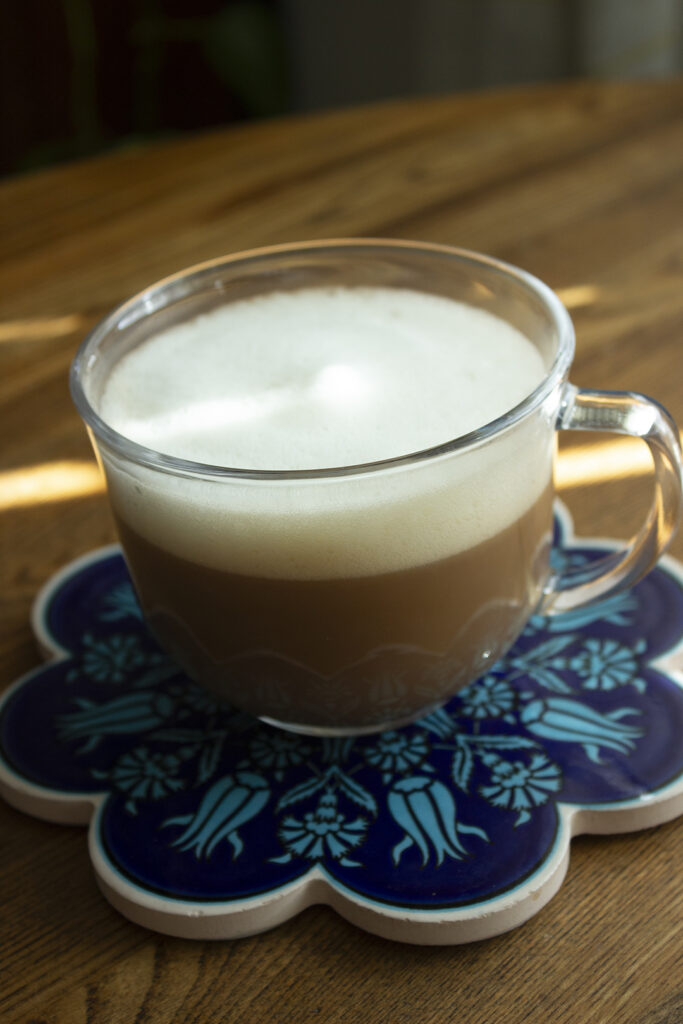 Hot Foamy Latte on Blue Coaster