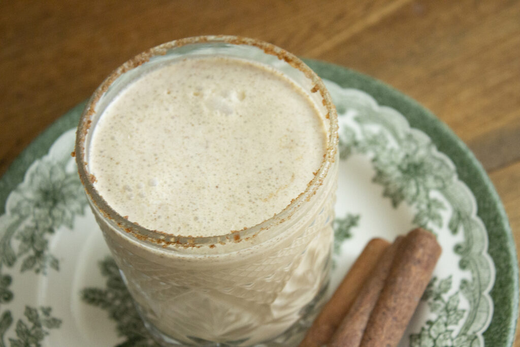 cold coquito with a cinnamon and sugar rim