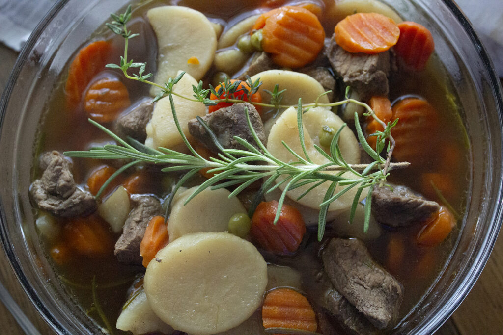 closeup of herbs in warm soup