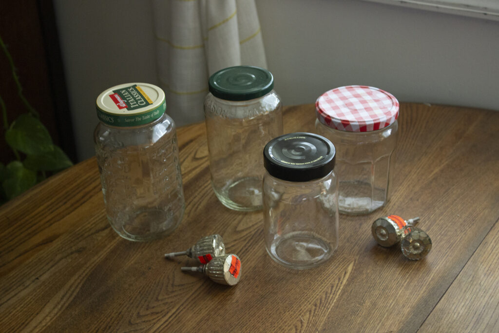 Recycled glass jars with gold cabinet knobs