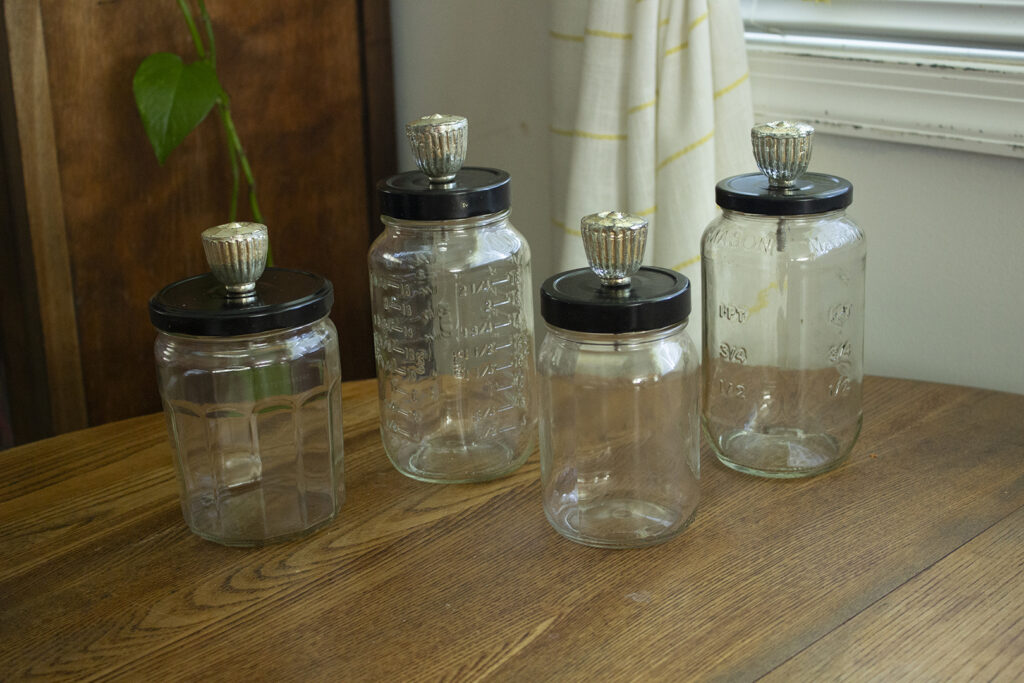 Glass Jar DIY: Glass jars with black lids and gold knobs
