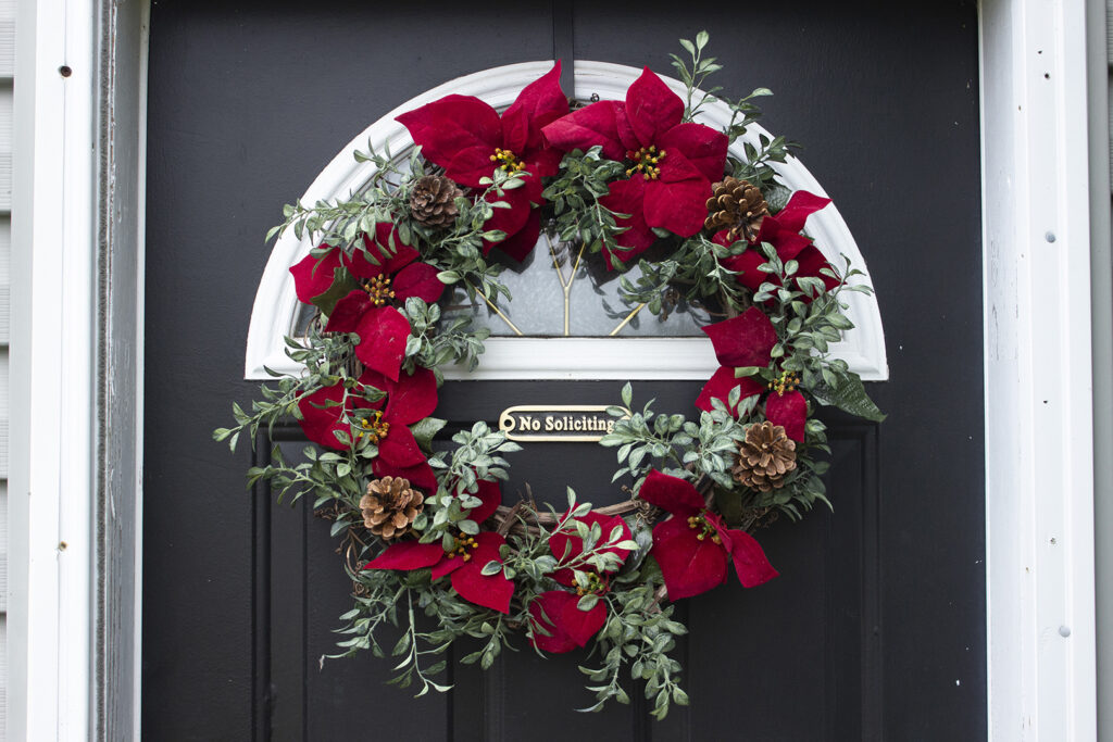 Wreath of red poinsettias and greenery