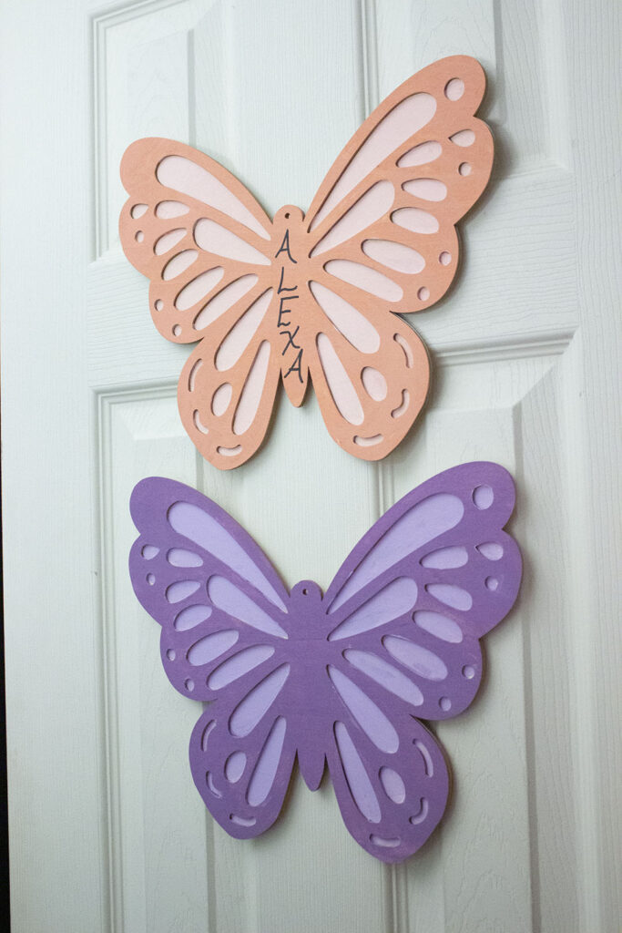 Butterfly bedroom décor: Wooden butterflies hanging on a door