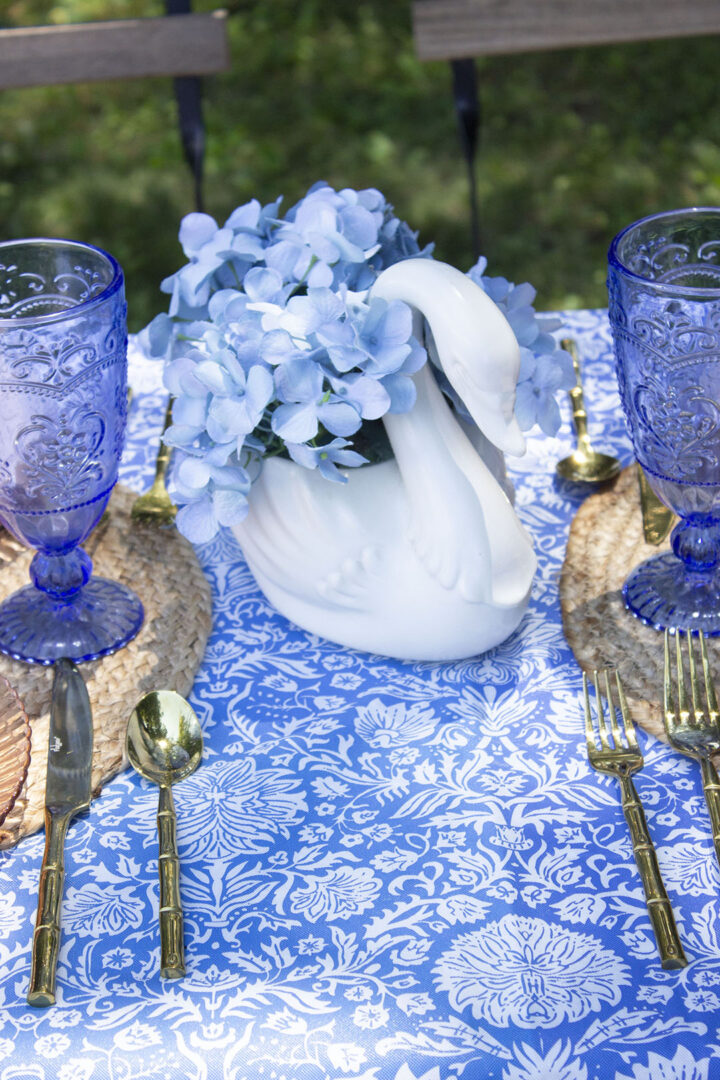 Swan vase filled with blue hydrangeas