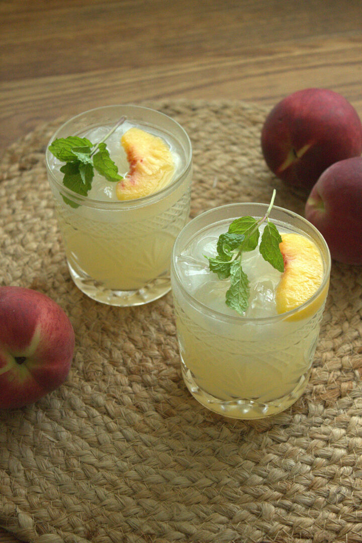 Peach Mint Vodka Cocktail in two rocks glasses
