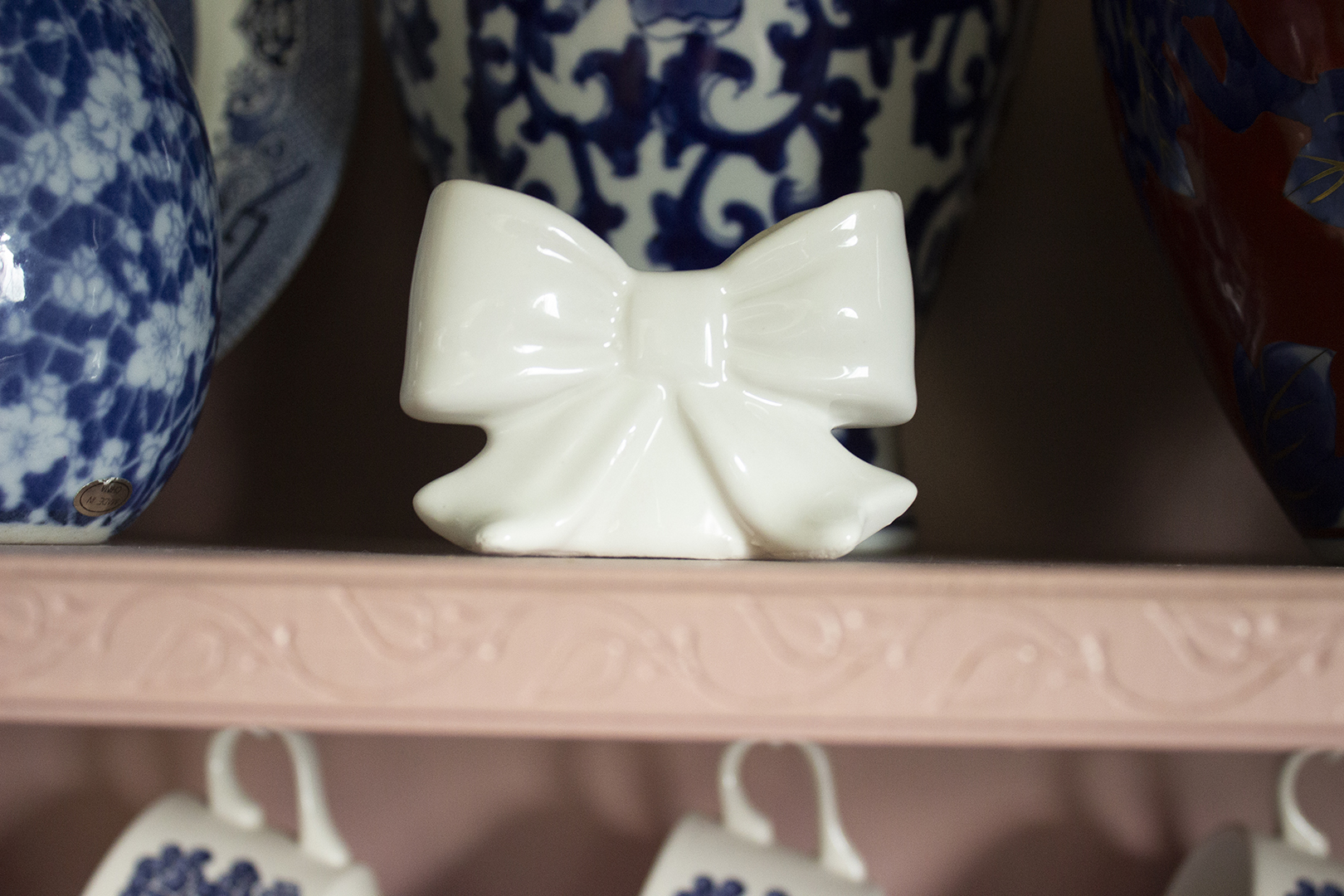 Small bow vase on a pink hutch