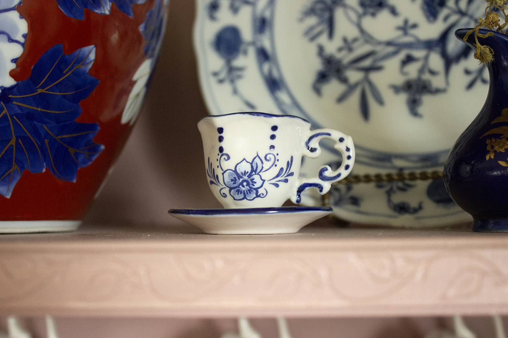 Small teacup on a pink hutch