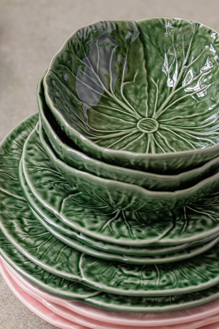 Stack of green and pink cabbageware plates and bowls