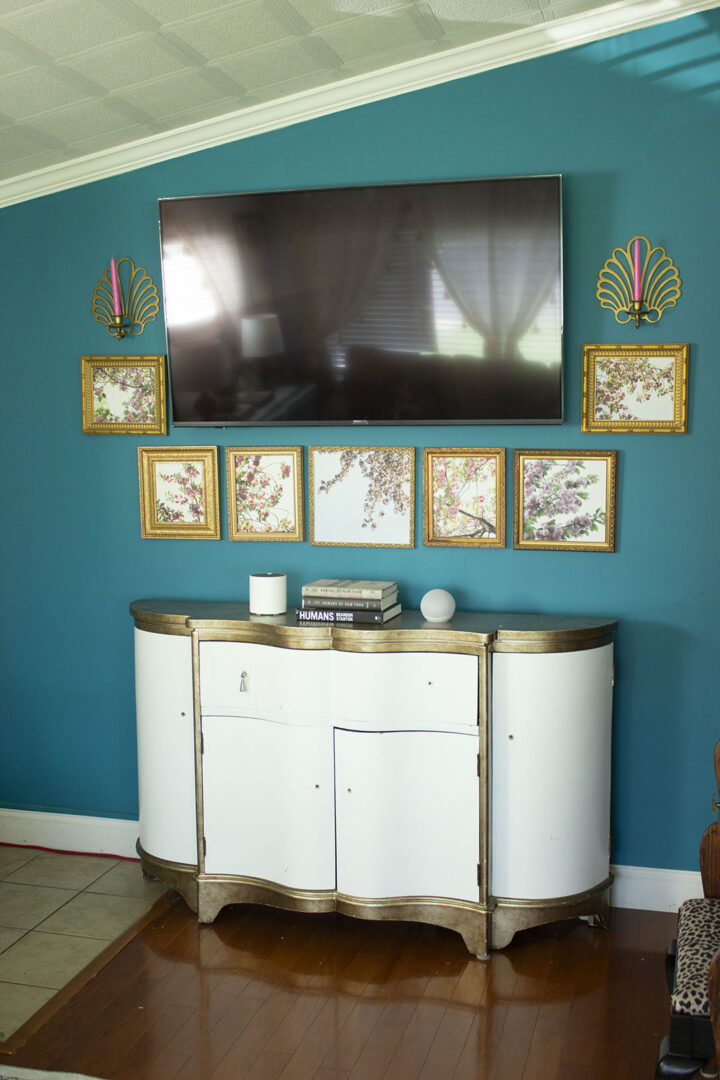 tv surrounded by floral photos