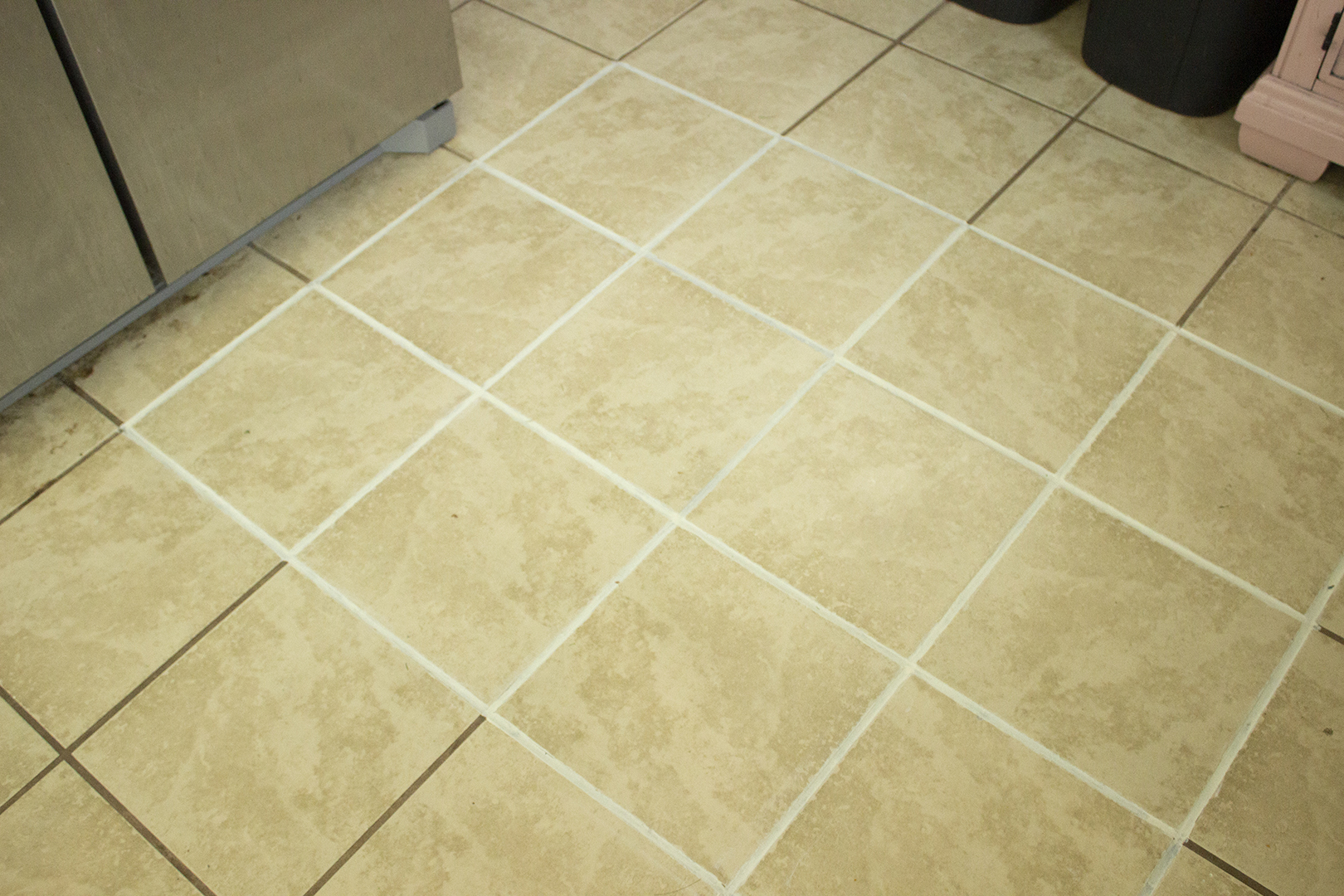 Grout Restoration: Partially restored grout on kitchen floor
